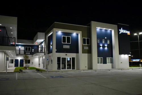 a large building with lights on the side of it at Blue Star Inn in Houston