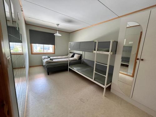 a room with a bunk bed and a couch at Cozy Scandinavian apartment central in Oslo - free parking and close to many amenities in Grorud