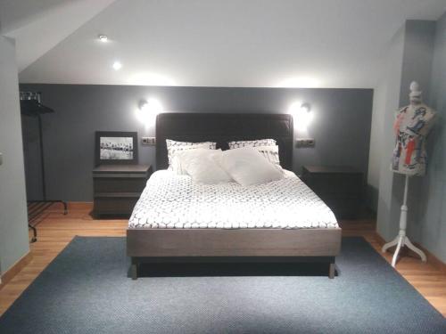 a bedroom with a large bed with white pillows at Chalet Miranda. VV-1595-AS in Avilés