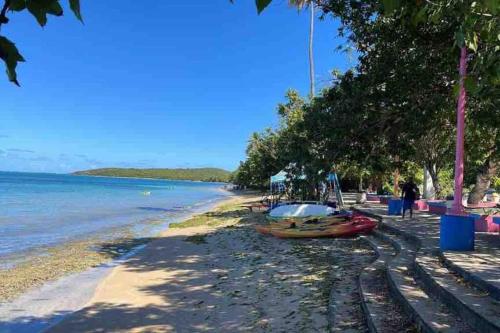 a beach with a group of boats on the shore at Beach Front Apartments Seven Seas in Fajardo