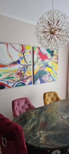 a dining room with a table and two chairs at Apartament Stephen in Constanţa