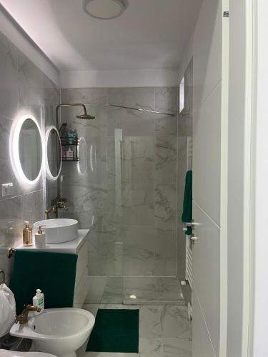 a bathroom with a sink and a toilet and a mirror at CENTRAL VIEW APARTAMENT in Arad
