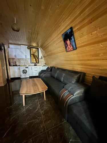 a living room with a leather couch and a table at Chalet Violeta in Gonio