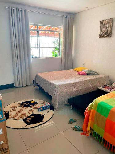 a room with a table in the middle of a room at Casa de Campo com Wi-Fi churrasq e piscina em MG in Lagoa Santa
