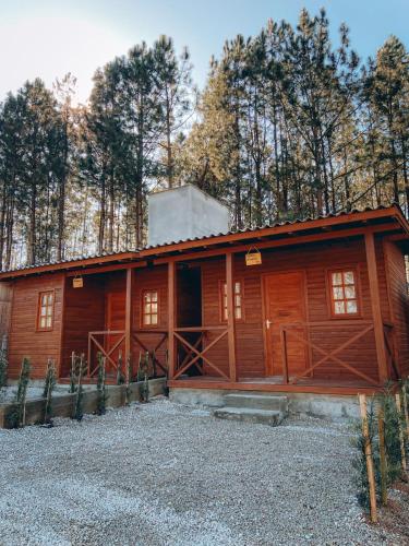 a large wooden cabin with trees in the background at Pousada Doce Aconchego - Grão Pará - Aiurê in Aiuré