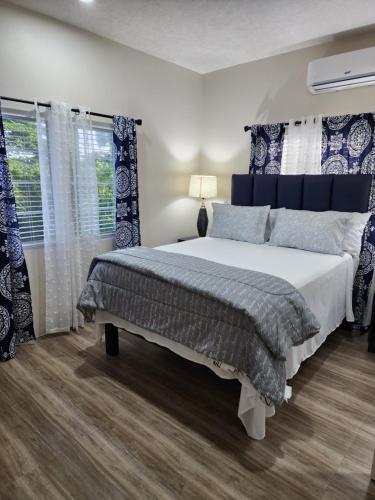 a bedroom with a large bed and a window at Paradise nestled between Montego Bay and Negril in Hopewell