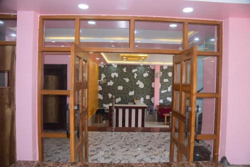 an open door into a room with a table at Hotel Gridhakuta International in Rājgīr