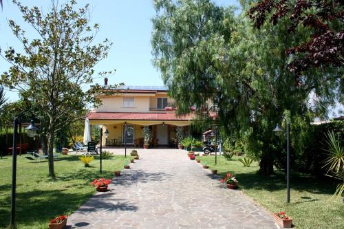 a walkway in front of a building with trees at Villa Brunella in Agropoli