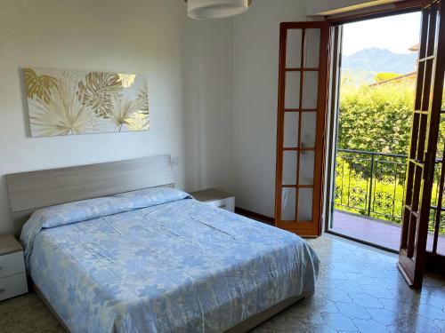 フォルテ・デイ・マルミにあるVilla Chiaraのベッドルーム1室(ベッド1台付)、バルコニーへのドアが備わります。