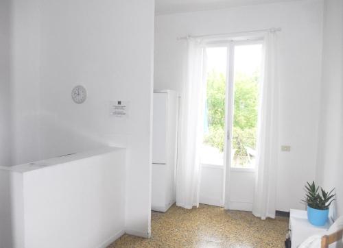 a white room with a door and a window at La Pergola in Vezzano Ligure