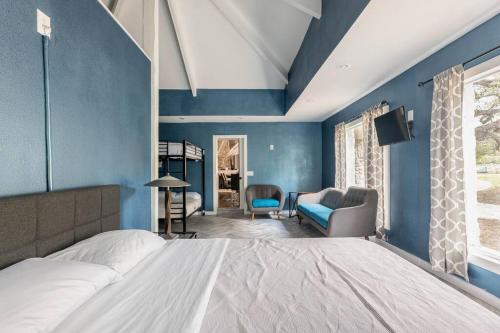 a bedroom with a large bed and blue walls at Old Oasis in Manchaca