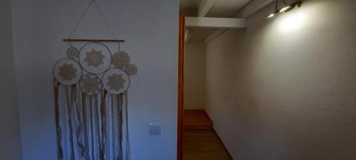 a hallway with a wall with a painting on it at Casa Esmar in Odemira