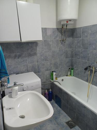 a bathroom with a sink and a bath tub at Putnik Gavrila Principa 193 in Višegrad