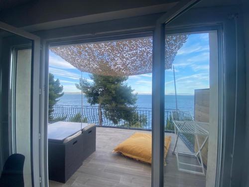 a sliding glass door with a view of the ocean at Appartement T4 terrasse et vue in Istres