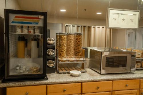 a kitchen with a counter top with a microwave at Americas Best Value Inn Lynnwood in Lynnwood