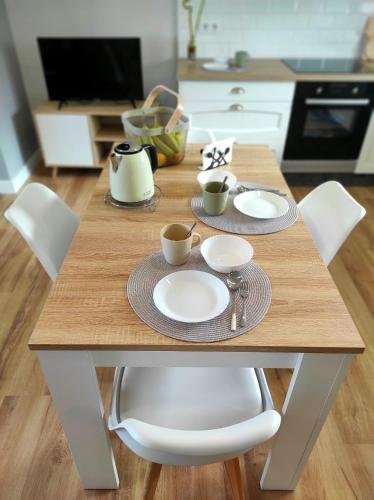 a wooden table with cups and saucers on it in a kitchen at Ortegal Beach & Seacliffs in Cariño