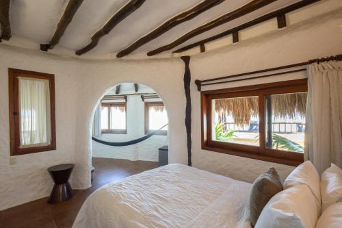 Ein Bett oder Betten in einem Zimmer der Unterkunft Las Nubes de Holbox