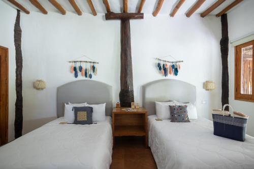 Ein Bett oder Betten in einem Zimmer der Unterkunft Las Nubes de Holbox