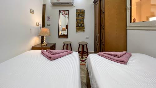 Voodi või voodid majutusasutuse Atlantis Pyramids Inn New toas