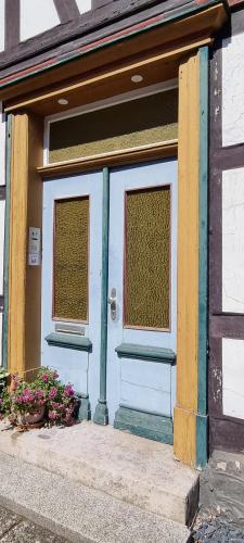 a front door of a house with two windows at FeWo zur alten Tischlerei in Herzberg am Harz
