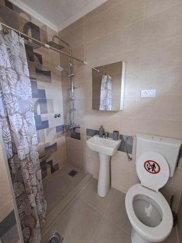 a bathroom with a toilet and a sink at Lazarov Apartments in Nov Dojran