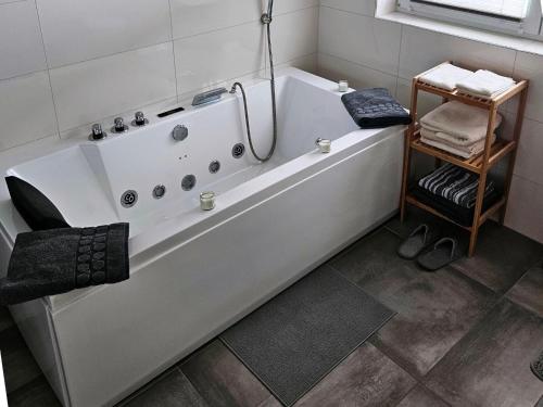 a white bath tub sitting in a bathroom at Apartment with sauna and panoramic view in Inzell in Inzell