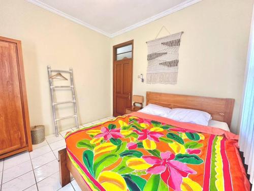 a bedroom with a bed with a colorful blanket at kuta 5BR private villa pool ,near airport, in Kuta