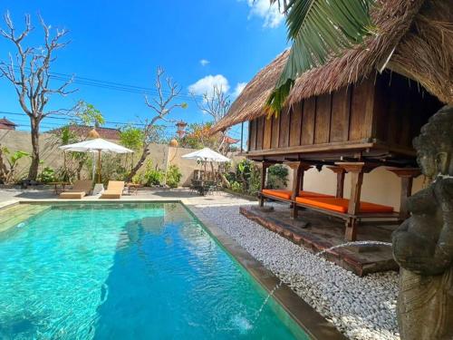 a villa with a swimming pool and a resort at kuta 5BR private villa pool ,near airport, in Kuta