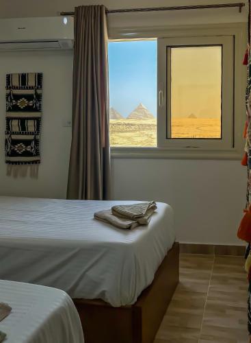 Voodi või voodid majutusasutuse Atlantis Pyramids Inn New toas
