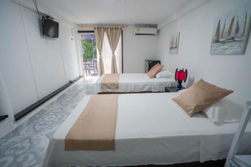 Una cama o camas en una habitación de Posada Jasmina Place