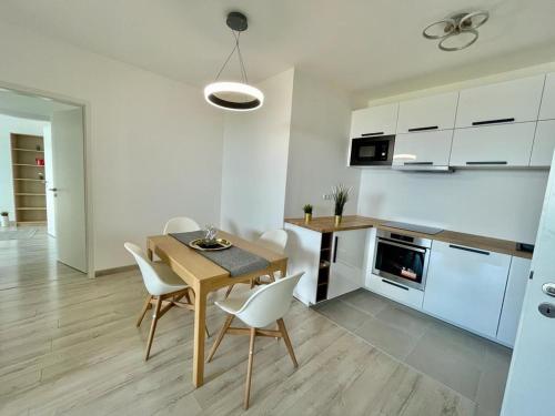 a kitchen and dining room with a table and chairs at Penthouse Design Young #4bedroom #2bathroom #terrace #freeparking in Budapest