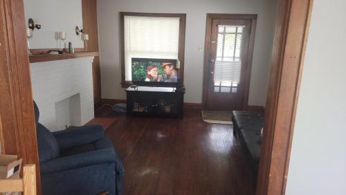uma sala de estar com uma televisão e um sofá em Quiet 3 bed with fenced yard em Columbus