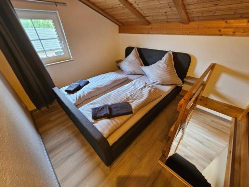 a bedroom with a bed with two pillows on it at Natur- und Aktivresort Senftenberg in Schipkau