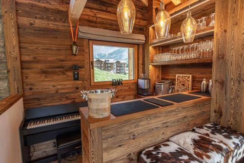 a kitchen in a log cabin with a stove at Sonnhalde II - Luxury Chalet in Saas-Fee