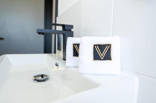 a bathroom sink with towels on a counter at V Business Apartments Böblingen in Böblingen
