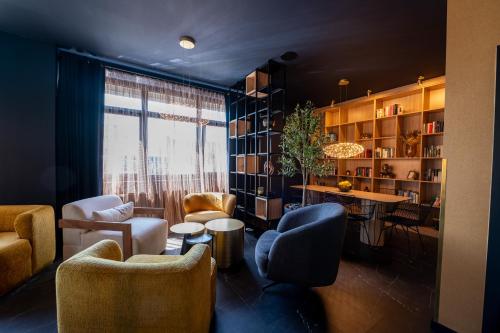 a living room with chairs and a table and a window at V Business Apartments Böblingen in Böblingen