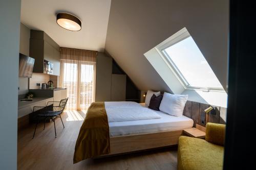a bedroom with a bed with a large window at V Business Apartments Böblingen in Böblingen
