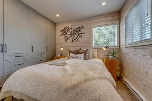 a bedroom with a large bed and a window at creekside Innsbrook in Whistler