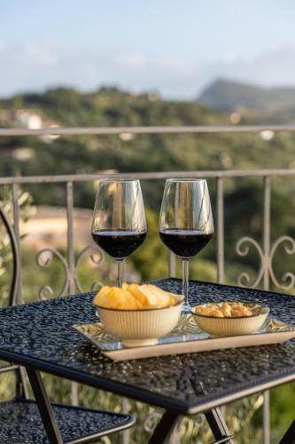 a table with two glasses of red wine and bread at Al Calar del Sole in Massa Lubrense
