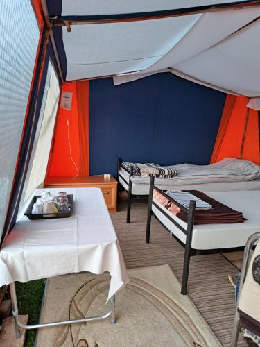 dwa łóżka i stół w namiocie w obiekcie MFN - Šator 1 w mieście Visoko