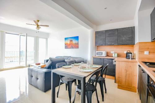 une cuisine et un salon avec une table et un canapé dans l'établissement La Canebière - Appart 2 chambres avec terrasse, à Marseille
