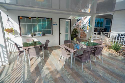 a dining room with a table and chairs on a patio at Posada Jasmina Place in Providencia