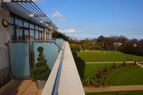 a balcony of a building with a view of a garden at Radisson Blu St. Helen's Hotel in Stillorgan