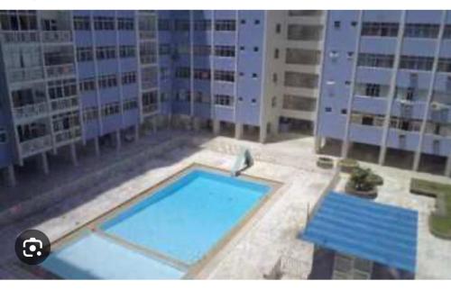a large swimming pool in front of some buildings at Apartamento em Boa Viagem in Recife