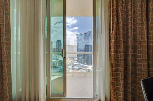 a window with a view of a city skyline at Premium Suite MGM Signature HIGH FLR Balcony Strip View in Las Vegas