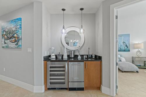 a bathroom with a sink and a mirror at Turquoise C1706 in Orange Beach