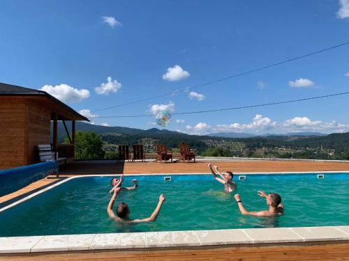 a group of people in a swimming pool at Байка Карпат in Vorokhta