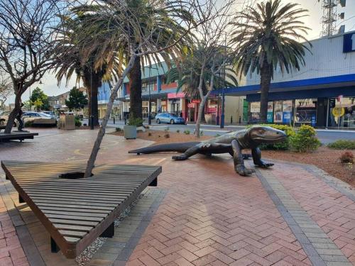 a statue of a turtle sitting next to a bench at Home Plus TAREE CBD in Taree