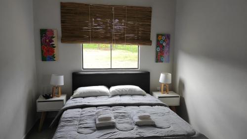 una camera da letto con un grande letto con due comodini di La Hacienda a Atyrá