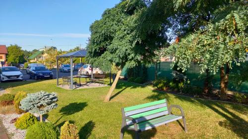 貝烏哈圖夫的住宿－Apartament GUNER，绿地长凳坐在草地上
